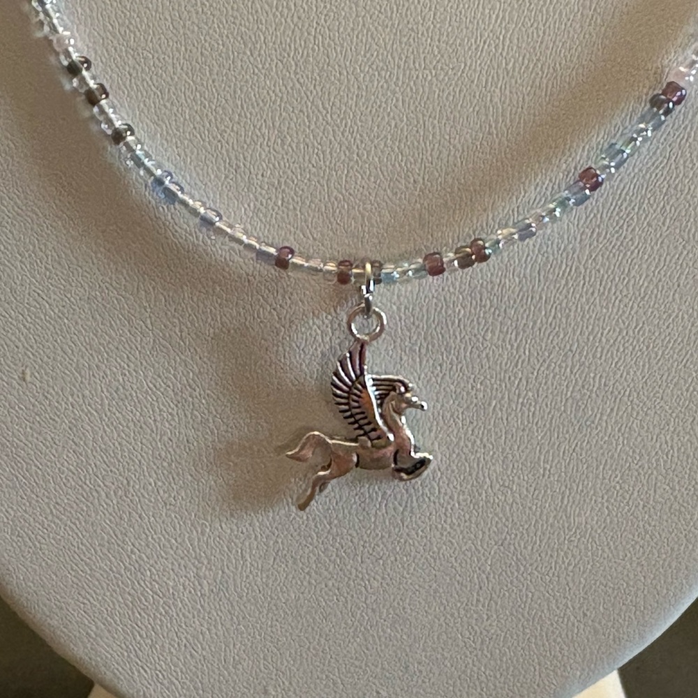 Hand beaded necklace with pegasus charm.